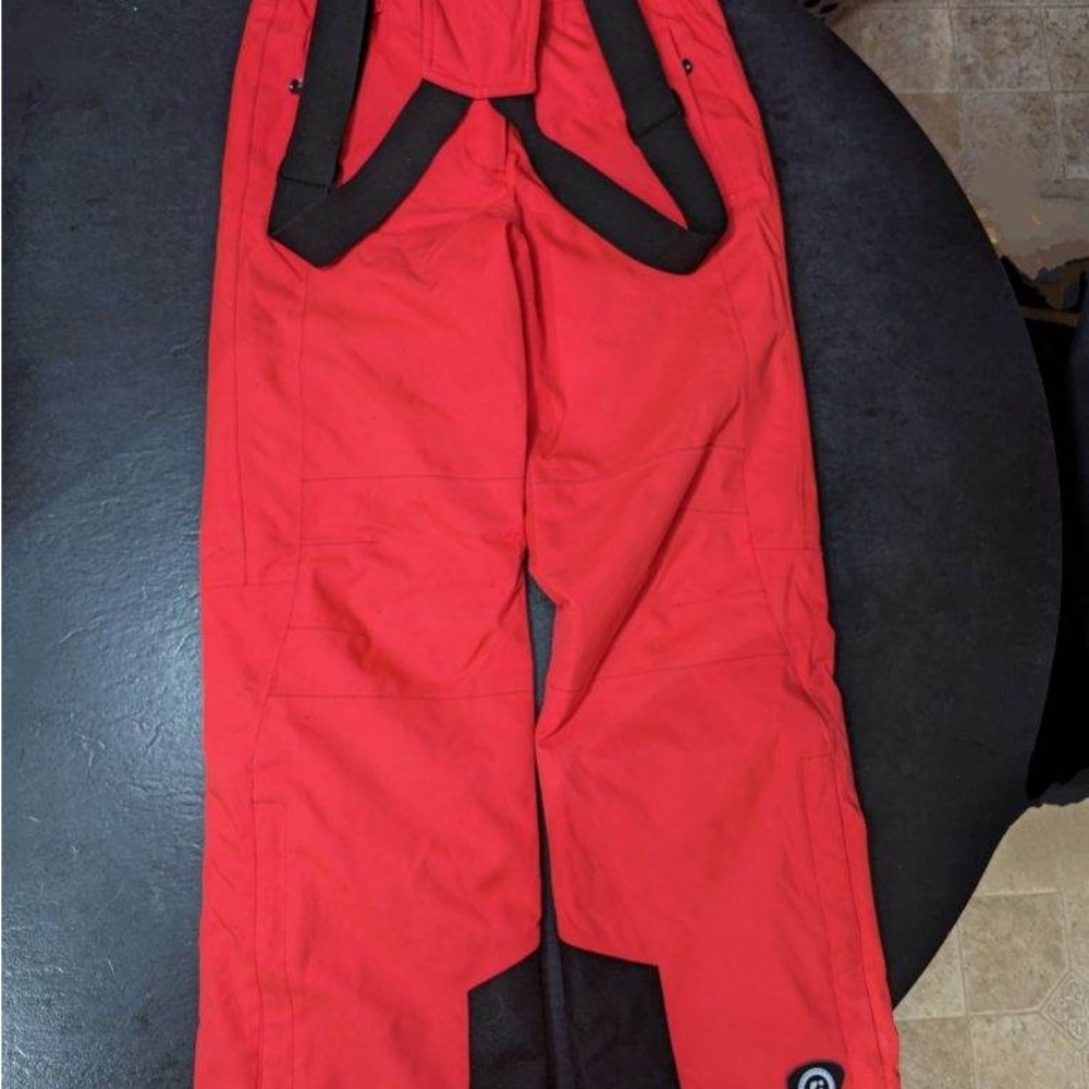Snow pants, look red in the photo but actually reddish/bright pink.
